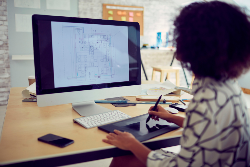 Designer using AI-powered digital home design software to review floor plans and improve material planning and construction efficiency