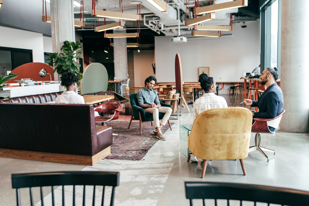 Residents using a shared co-working lounge inside a multifamily building, reflecting modern amenity design that supports hybrid and remote work.