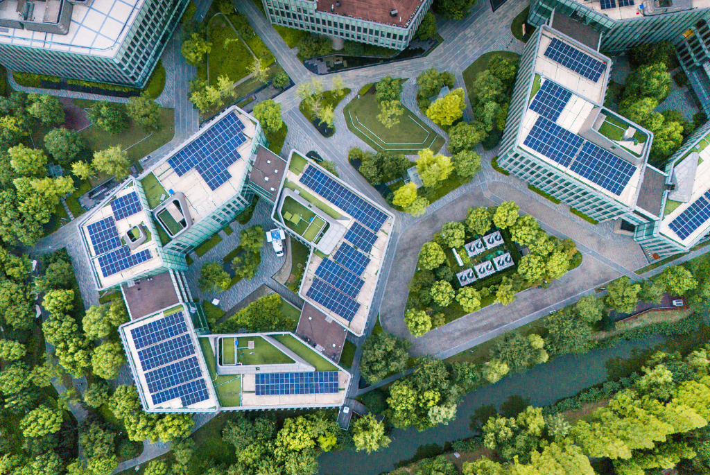 Aerial view of multifamily buildings with rooftop solar panels, illustrating low-carbon design and renewable energy integration in sustainable housing developments
