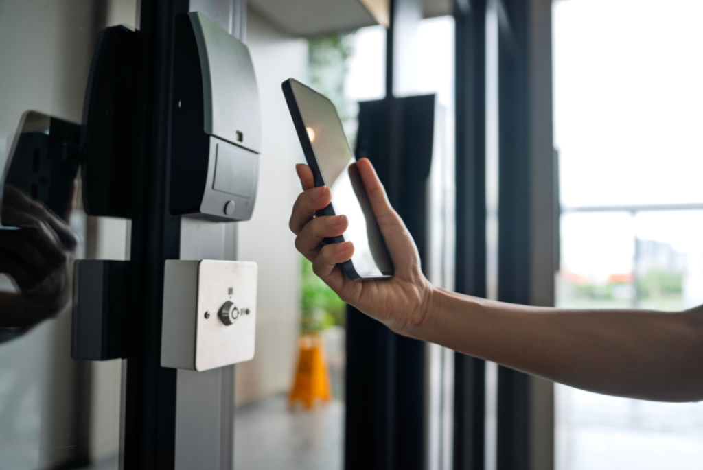Resident using a smartphone to access a touchless entry system in an apartment building.
