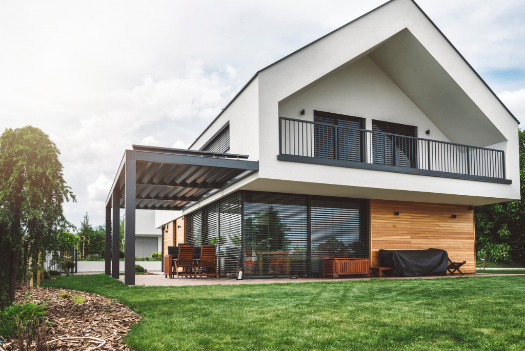 Modern custom-built single-family home with contemporary architecture, large windows, and covered outdoor living space.