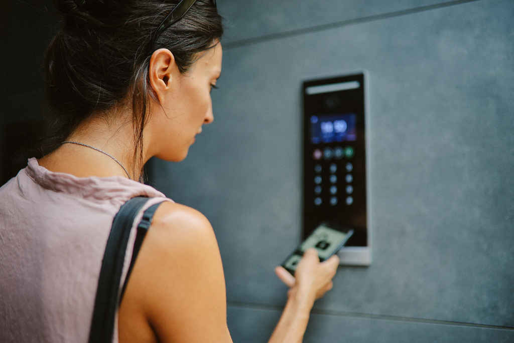 Resident using a smartphone for keyless entry access at a multifamily apartment building.